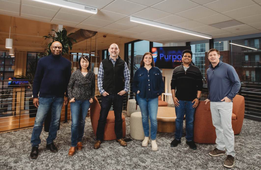 Purpose Financial employees standing together in one of our offices