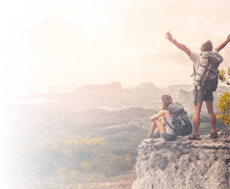 People enjoying the view on top of a mountain